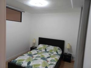 a bedroom with a bed and two lamps in it at Chez Sab in Carcès