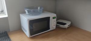 a microwave with a bowl on top of it at Budanes 1 in Stykkishólmur
