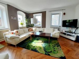 a living room with a couch and a coffee table at Große Altbauwohnung auf dem Land in Kallham