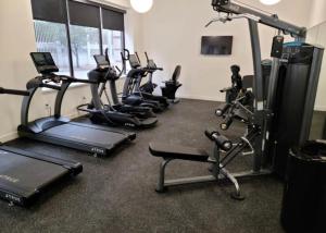 a gym with several treadmills and exercise bikes at Cozy Apt Across From Ballpark Busch Stadium in Saint Louis