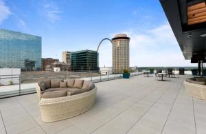 a patio with a couch on the roof of a building at Cozy Apt Across From Ballpark Busch Stadium in Saint Louis