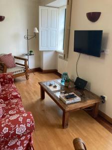 a living room with a couch and a coffee table at Tia Rita House in Figueira da Foz