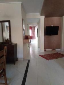 a living room with a flat screen tv on a wall at Bel appartement plein centre avec double terrasse in Oujda