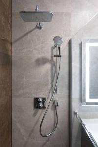 a shower with a shower head in a bathroom at Lux oasis with private parking in Zagreb