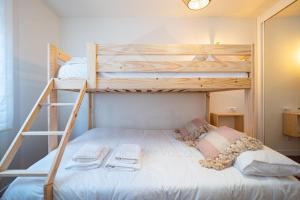 a bedroom with two bunk beds and a ladder at La Luca Apartamento in Llanes