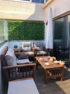 a patio with a table and chairs and a umbrella at Serene House in Playa del Hombre in Playa del Hombre
