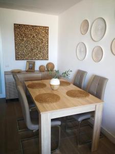 a dining room table with chairs and plates on the wall at Serene House in Playa del Hombre in Playa del Hombre