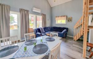 a living room with a blue couch and a table at Lovely Home In Alingss With Wifi in Alingsås