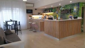 a bar in a restaurant with chairs and a counter at Hotel Cimarosa in Riccione
