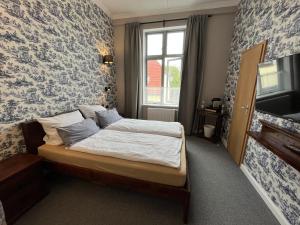 Postel nebo postele na pokoji v ubytování Hoffmanns Holsteinisches Haus + 20 fotografií