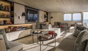 a living room with couches and a table at Four Seasons Explorer Palau - Cruising Resort in Koror