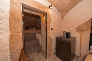 a small room with a staircase and a bed in it at Suite Pietra Bianca - Relax & SPA in Martina Franca +10 photos