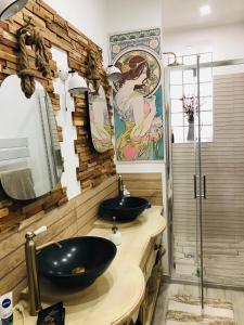 a bathroom with two sinks and a mirror at Bras de Mer in Cérans-Foulletourte