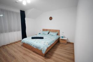 a bedroom with a large bed and a wooden floor at La 2 pruni 