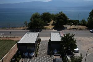 a view of a bus stop with the ocean in the background at Pashkaj Hotel in Pogradec