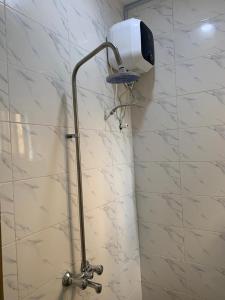 a bathroom with a shower with a light on the wall at Dlulus Ventures Mini Flat apartment sabo in Lagos