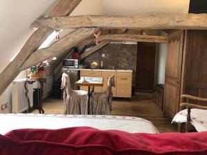 a kitchen with a table and chairs in a room at Aux Logis de la Solre in Ferrière-la-Petite +55 photos