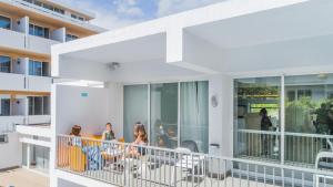a group of people on a balcony of a building at Hotel Londres Estoril / Cascais in Estoril