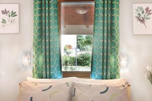 a bedroom with green and white curtains and a window at Apartment Ivana in Roč