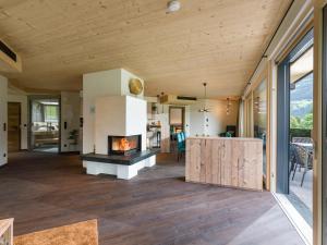 a living room with a fireplace in a house at Villa Himmlgassl Private Spa in Zellbergeben +42 photos