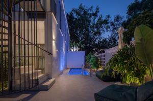 a courtyard of a house with a swimming pool at Adrop Pool Suites in Paphos City