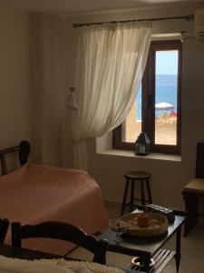 a bedroom with a bed and a window and a table at Evi's House in Kandia