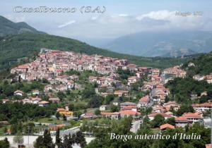 a town on a hill with houses and trees at L'Arco Antico in Casalbuono