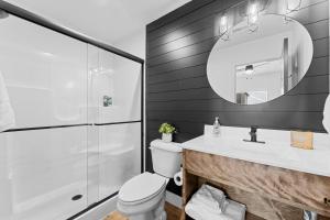 a bathroom with a toilet and a sink and a mirror at Moonlight Manor home in Hollister