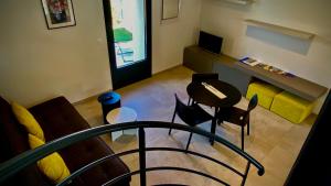 a living room with a table and chairs at Gîtes Du Mas de Surlan in Chantemerle-les-Blés