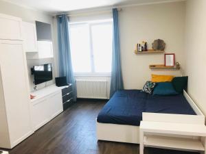 a small bedroom with a bed and a television at Donna Flor casa vacanze in Barletta