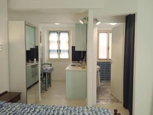 a room with a bed and a sink and a bathroom at La casa di Uccia in Trieste