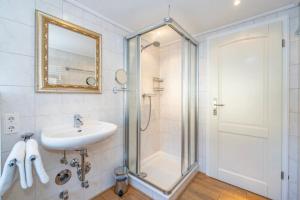 a bathroom with a shower and a sink at Feriendorf Sylt Deutschland in Tinnum