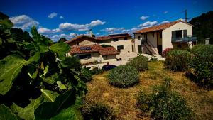 a house with a yard with plants in front of it at Gîtes Du Mas de Surlan in Chantemerle-les-Blés