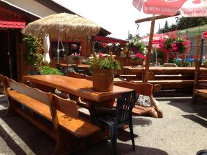 a wooden table and chairs with plants on it at La Godille in Andon