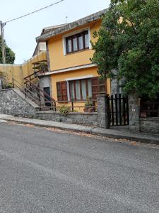 a yellow house on the side of a street at Grace House in Cuglieri