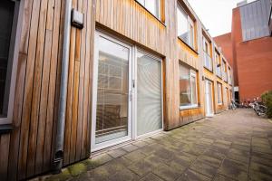 a building with sliding glass doors on the side of it at Delightful 2 Bedroom Apartment in Eindhoven