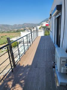 a wooden deck with a bench on top of a building at Luxury new summer house in Dalaman