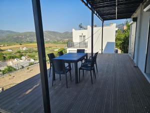 a patio with a table and chairs on a deck at Luxury new summer house in Dalaman