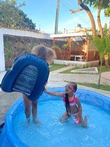 a woman is helping a little girl in a pool at Villa by the beach Mombasa in Mtwapa