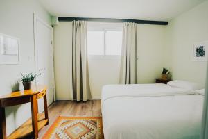 a bedroom with two beds and a window at ibex unique Desert Inn in Mitzpe Ramon