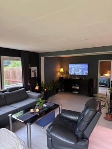 a living room with a couch and a tv at Sagavang in Trondheim