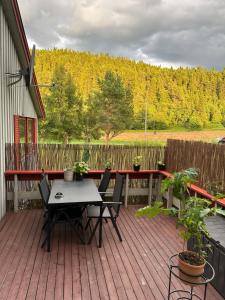 a patio with a table and chairs on a deck at Sagavang in Trondheim