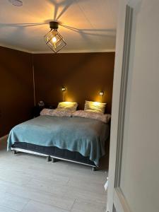 a bedroom with a large bed in a room at Sagavang in Trondheim