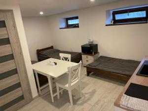 a small room with a table and a bed at Apartmán nad Bazilikou 2 in Třebíč