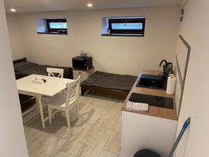 a kitchen and dining room with a table and a stove at Apartmán nad Bazilikou 2 in Třebíč