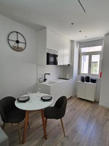 a kitchen with a table and chairs in a room at The Singular - Downtown Studio in Faro