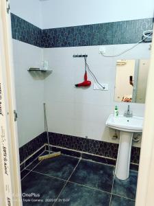 a bathroom with a sink and a mirror at RASA - The Ganges Rishikesh, Ganga Bhumi Apartment in Rishīkesh