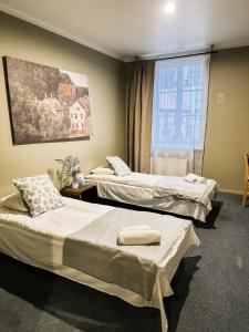 Posteľ alebo postele v izbe v ubytovaní Viesnīca Kandava