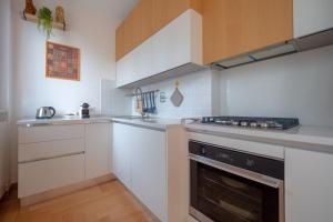 a kitchen with white cabinets and a stove top oven at [Apartment near Perugia] - Free Parking & A/C in Badiola