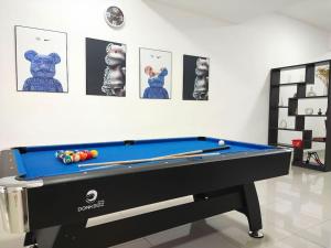 a pool table in a room next to a wall at No 68 Sunlight Homestay 4R3B - 24 Pax, Karaoke in Kuala Selangor